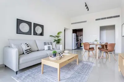 a living room with a couch and a table at Frank Porter - Fairview Residency in Dubai