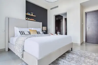 a large white bedroom with a large white bed at Frank Porter - Fairview Residency in Dubai