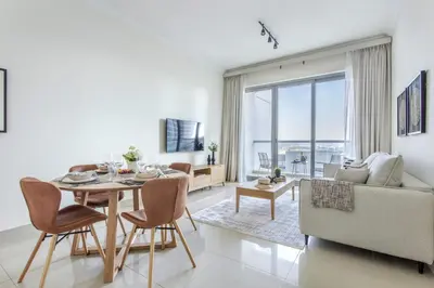 a living room with a table and a couch at Frank Porter - Fairview Residency in Dubai