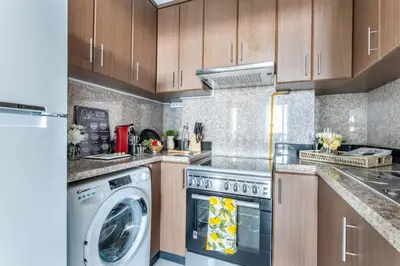 a kitchen with a washing machine and a washer at Frank Porter - Fairview Residency in Dubai