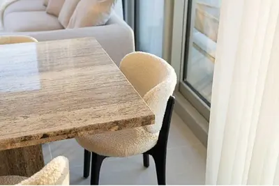 a wooden table and chairs in a room with a window at Oraya - Chic 2BR Apt in Downtown Dubai With City Views in Dubai