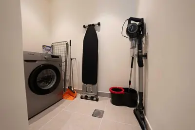 a camera next to a washing machine in a room at Oraya - Chic 2BR Apt in Downtown Dubai With City Views in Dubai