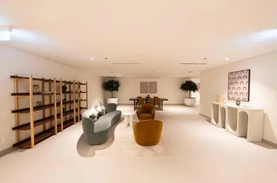 a large living room with couches and a table at Oraya - Chic 2BR Apt in Downtown Dubai With City Views in Dubai