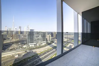 an office building with a view of the city at Studio with Burj Khalifa View - Upside Living in Dubai