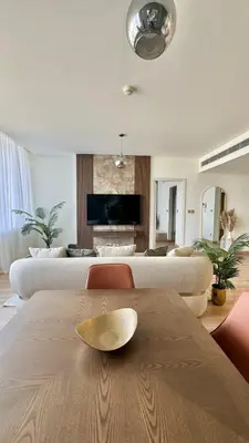 a living room with a table and a couch at LUXURY SPACIOUS - 1 BR - SKY GARDENS DIFC - Heart of Trade Centre and Dubai Mall in Dubai