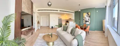 a living room with a couch and a table at LUXURY SPACIOUS - 1 BR - SKY GARDENS DIFC - Heart of Trade Centre and Dubai Mall in Dubai