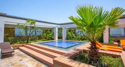 a backyard with a swimming pool and a palm tree at LUXURY SPACIOUS - 1 BR - SKY GARDENS DIFC - Heart of Trade Centre and Dubai Mall in Dubai