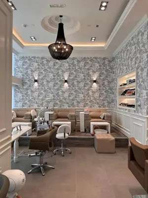 a barber shop with a hair salon with chairs and tables at LUXURY SPACIOUS - 1 BR - SKY GARDENS DIFC - Heart of Trade Centre and Dubai Mall in Dubai