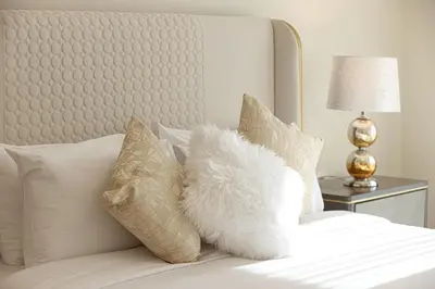 a white pillow sitting on top of a bed at Visionary Vista: 2BR Al Habtoor City in Dubai