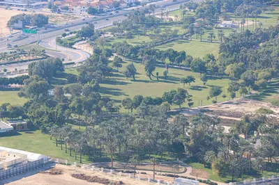 an aerial view of a park with trees and a road at Visionary Vista: 2BR Al Habtoor City in Dubai