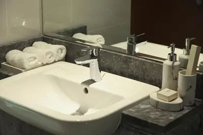 a white sink in a bathroom with a mirror at Visionary Vista: 2BR Al Habtoor City in Dubai
