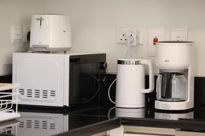 a kitchen with two coffee machines on a counter at Visionary Vista: 2BR Al Habtoor City in Dubai
