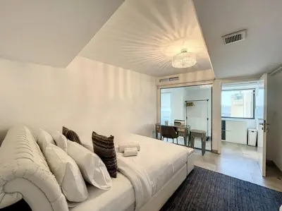 a large white bed in a room with a table at Rimal 3 - Incredible Two Bedroom in Dubai
