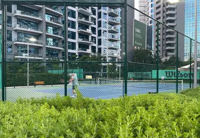 a person is playing tennis on a tennis court at Seven Palm, Private beach, Infinity Pool, High Floor 3BDR in Dubai