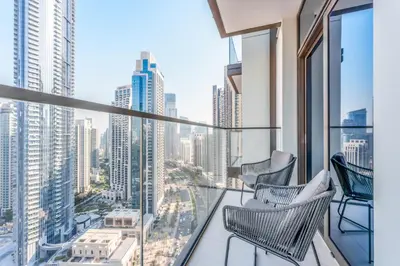 a balcony with chairs and a view of a city at Stayis -1 BR Burj Khalifa View Partial in Dubai