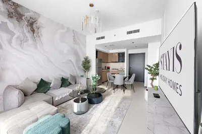 a living room with a couch and a table at Stayis -1 BR Burj Khalifa View Partial in Dubai