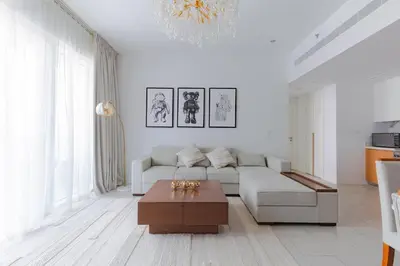 a white living room with a couch and a coffee table at La Vie, JBR private beach, private parking and pool in Dubai