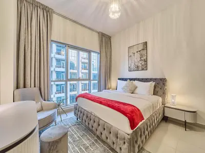 a bedroom with a bed and a large window at Golden Homes Boulverd Central 1BHK BLUE HEAVEN Near Dubai mall & burj khalifa Downtown Dubai in Dubai