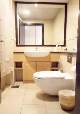 a bathroom with a sink and a toilet and a mirror at Full lake View 1bk Apartment in JLT 4 ppl early & late check in 10mn to Marina metro station in Dubai