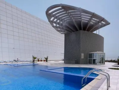 a swimming pool in front of a building at Full lake View 1bk Apartment in JLT 4 ppl early & late check in 10mn to Marina metro station in Dubai
