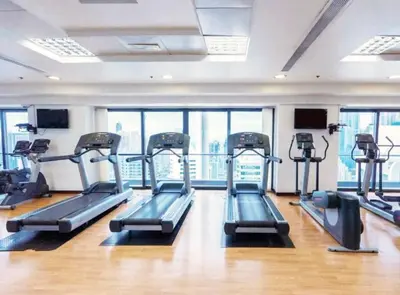 a gym with several tread machines in a building at Full lake View 1bk Apartment in JLT 4 ppl early & late check in 10mn to Marina metro station in Dubai