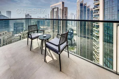two chairs and a table on the balcony of a building at Act One Act Two by Emaar, Downtown Dubai in Dubai