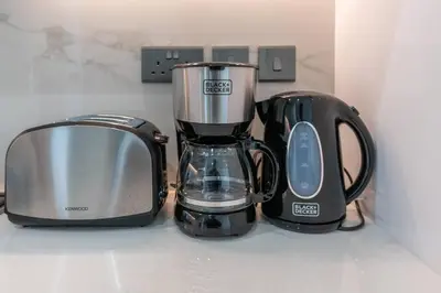 a blender and a toaster sitting on a counter at 2bdr 12min from Downtown in Dubai