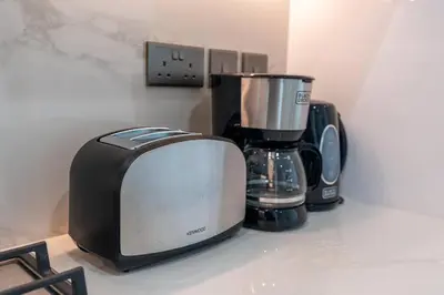a toaster and a blender sitting on a counter at 2bdr 12min from Downtown in Dubai