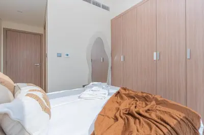 a bedroom with a bed and a large mirror at 2bdr 12min from Downtown in Dubai