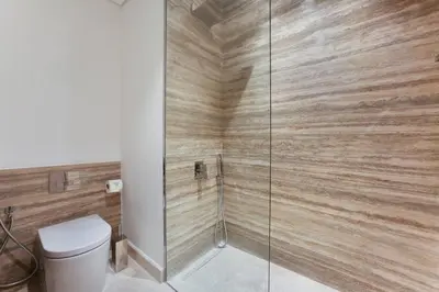 a bathroom with a toilet and a glass shower at Luxury Glam Studio Near Burj Khalifa Downtown in Dubai