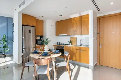 a kitchen with a table and chairs in a room at GuestReady - Above the clouds at Opera Grand in Dubai