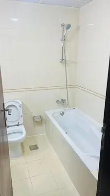 a bathroom with a toilet and a bath tub and a sink at Master Room with attach Bathroom Near Mall of the Emirates in Dubai