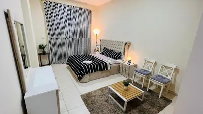 a small room with a bed and a table at Master Room with attach Bathroom Near Mall of the Emirates in Dubai