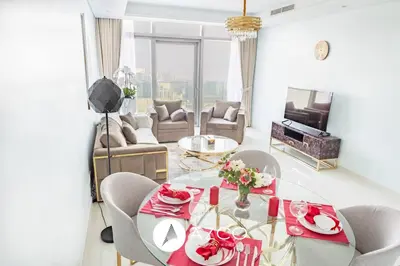 a living room with a table and a couch at 1BR Apartment in Paramount Midtown in Dubai