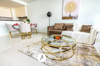 a living room with a couch and a glass table at 1BR Apartment in Paramount Midtown in Dubai