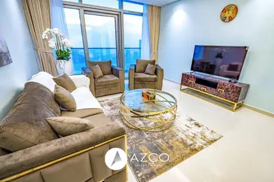 a living room with a couch and a tv at 1BR Apartment in Paramount Midtown in Dubai