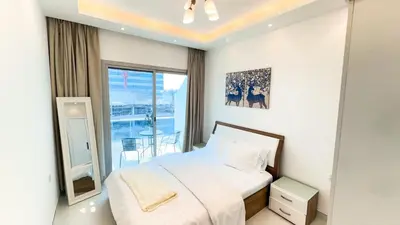 a bedroom with a bed and a large window at Dubai Marina (Marina Diamond 2) 1 Bedroom Apt. in Dubai