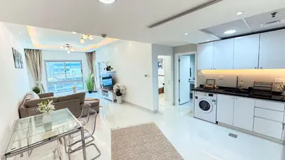 a kitchen and living room with a couch and a table at Dubai Marina (Marina Diamond 2) 1 Bedroom Apt. in Dubai