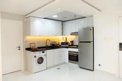 a kitchen with a refrigerator and a washing machine at Dubai Marina (Marina Diamond 2) 1 Bedroom Apt. in Dubai