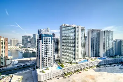 an aerial view of a city with tall buildings at Canal-View Serenity: Modern Studio in Sterling in Dubai