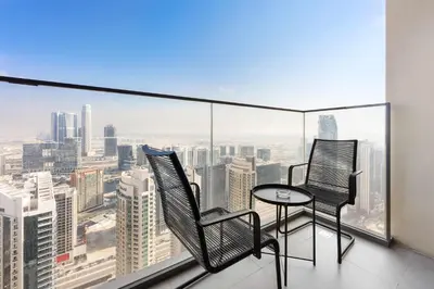 two chairs and a table on a balcony with a view at Silkhaus Luxurious 1 BDR Stunning View in Dubai