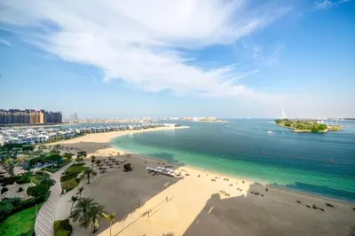 a view of a beach with people and the ocean at Seaview-Shoreline4-Palm Jumeirah in Dubai