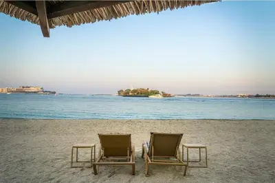 two chairs sitting on a beach with the ocean at Seaview-Shoreline4-Palm Jumeirah in Dubai