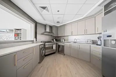 a kitchen with white cabinets and stainless steel appliances at Seaview-Shoreline4-Palm Jumeirah in Dubai
