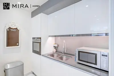 a kitchen with a sink and a microwave at Mira Holiday Homes - Luxury 1 bedroom in Bluewaters Island in Dubai