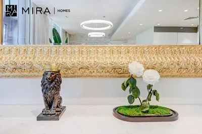 a couple of vases on a table with a plant at Mira Holiday Homes - Luxury 1 bedroom in Bluewaters Island in Dubai