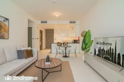 a living room with a couch and a table at 2ndHome - District One Residences , Residence 14 in Dubai