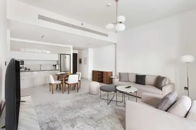a living room with a couch and a kitchen at Silkhaus Beach Lovers 1BDR with Marina View in Dubai