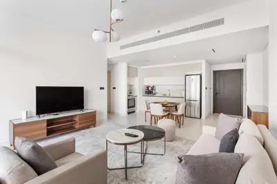 a living room with a couch and a tv at Silkhaus Beach Lovers 1BDR with Marina View in Dubai