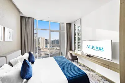 a hotel room with a bed and a tv at ALiving Deluxe Studio I DAMAC Maison Prive, Business Bay -1204 in Dubai